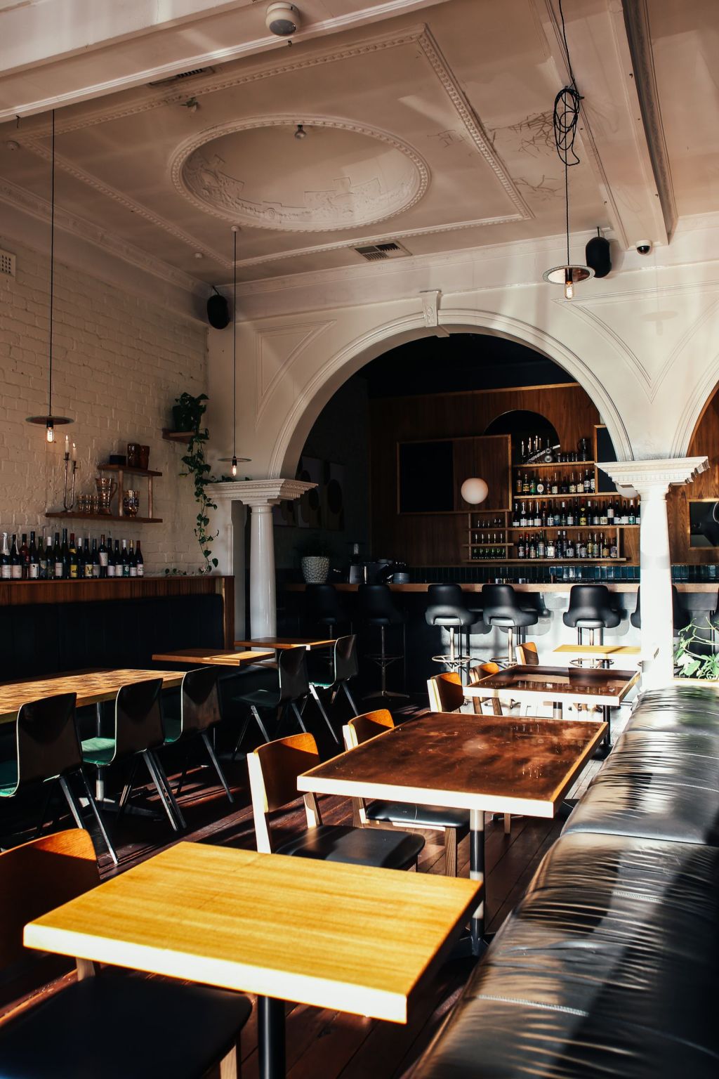 Warm classic restaurant interior with wood furniture and elegant seating