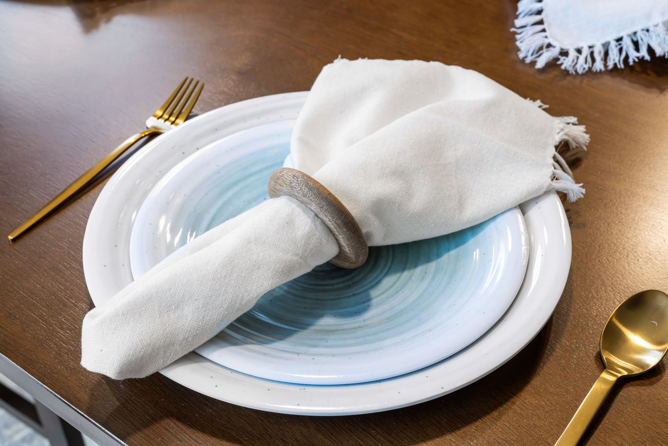Elegant table setting with a linen napkin, white plates and cutlery