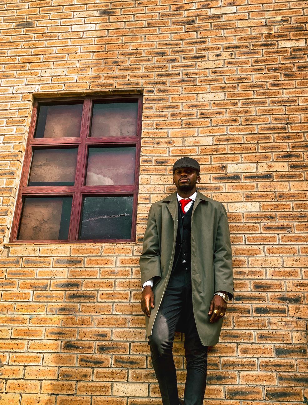 Man wearing a classic overcoat outdoors, an example of timeless men's style