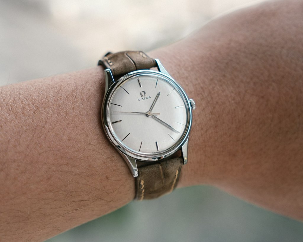 Vintage wristwatch with a leather strap on a wrist